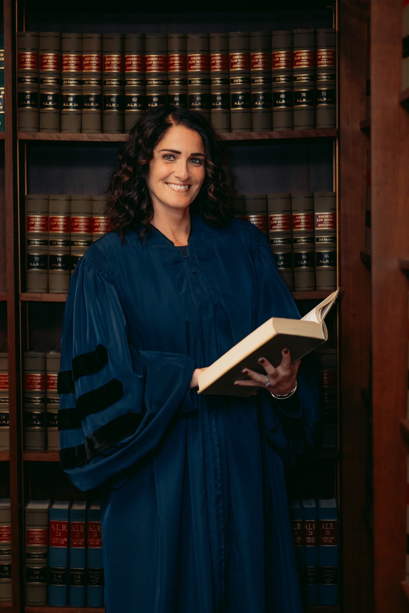 Judge Khoury in her robe reading a law book