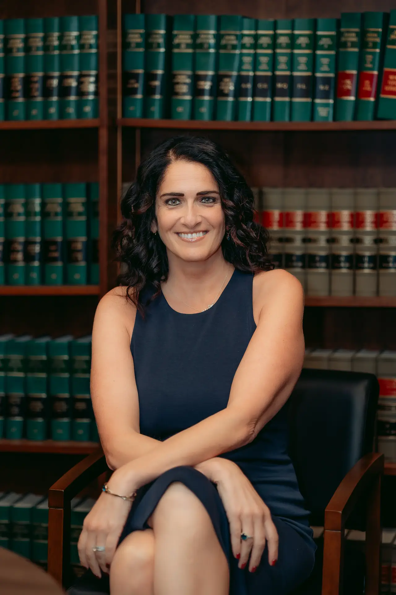 Nicole Khoury smiling, seated in the law library